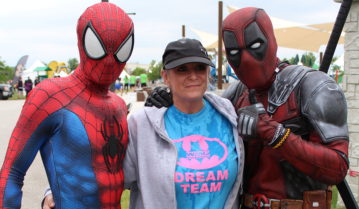 WMG employee with Spiderman and Deadpool