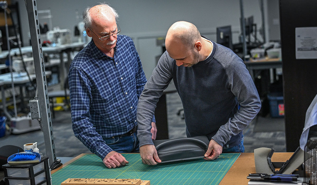 2 WMG employees working with trim