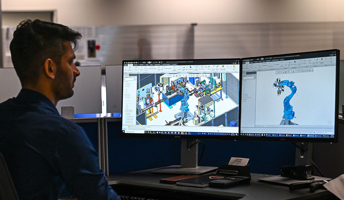 WMG employee working on two computer monitors with design