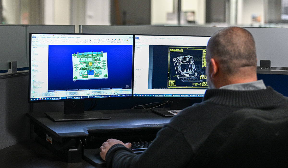 WMG employee working on two computer monitors