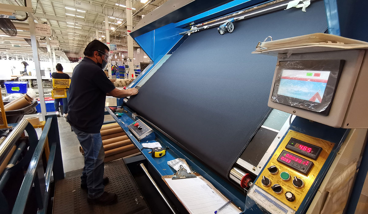 WMG employee in Mexico on lamination equipment